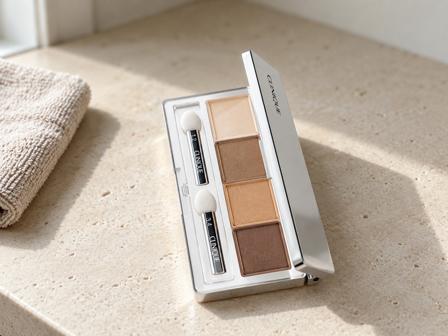 Clinique All About Shadow Quad in Teddy Bear on a warm stone vanity