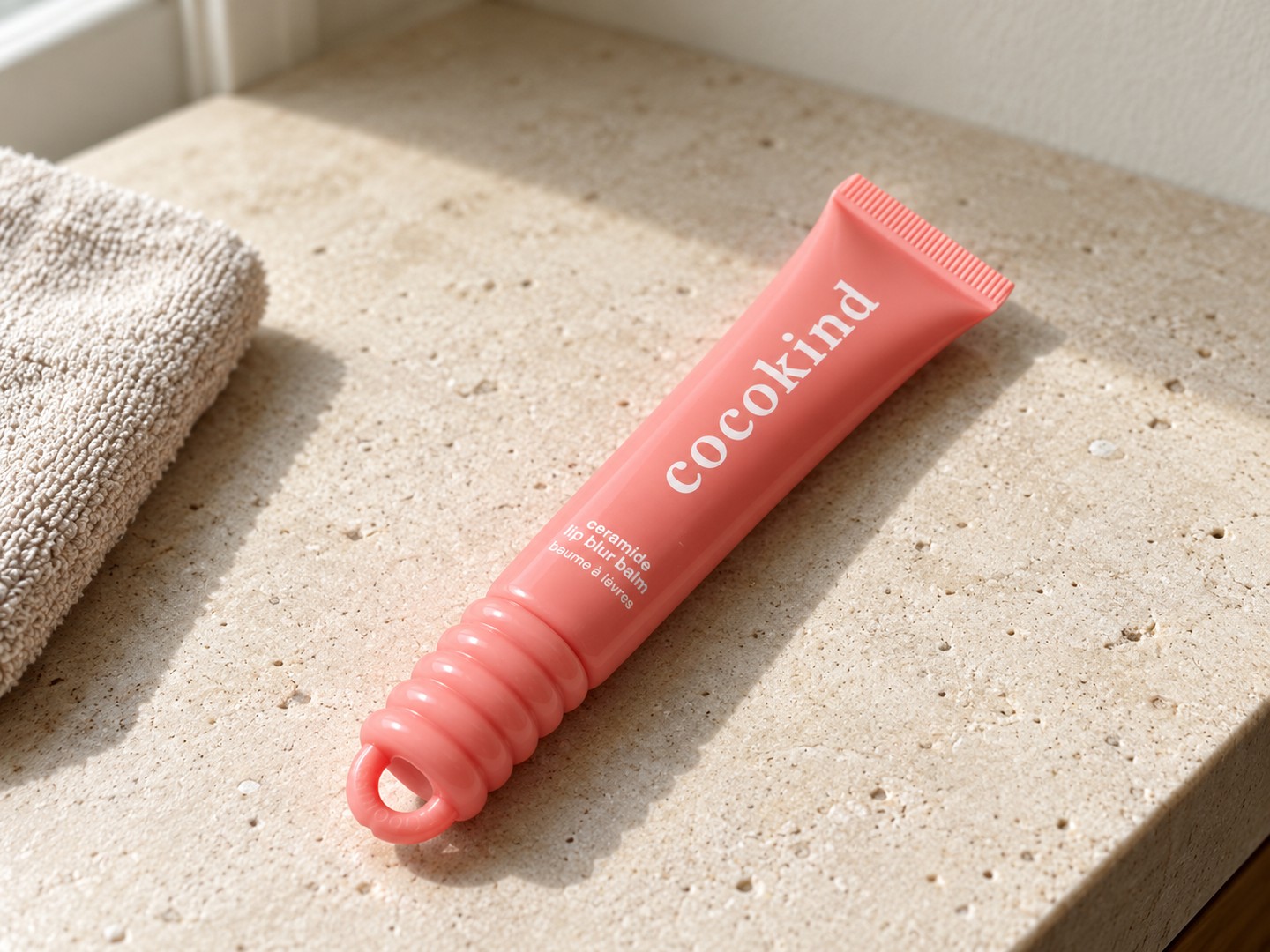 cocokind Ceramide Lip Blur Balm — Be Kind on a warm stone vanity