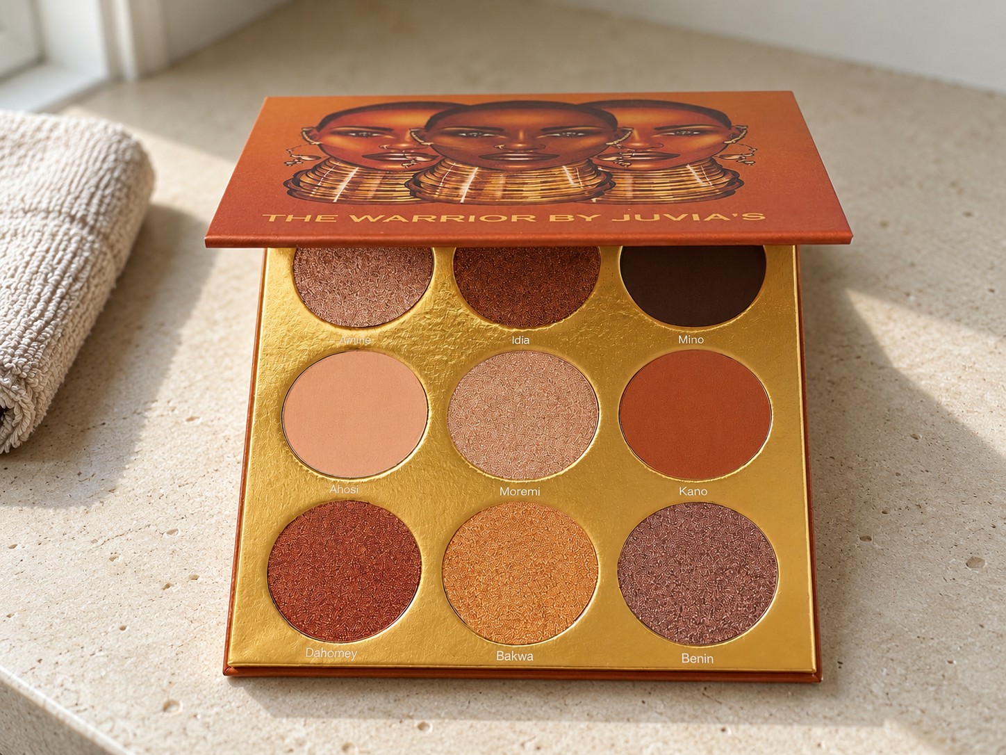Juvia’s Place The Warrior Palette on a warm stone vanity