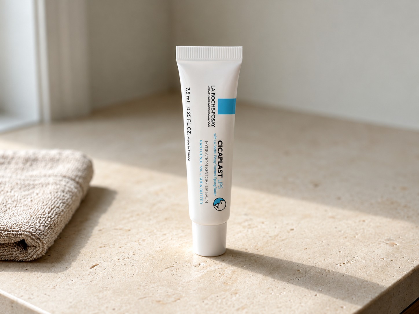 La Roche-Posay Cicaplast Lips Hydration Restore Lip Balm on a warm stone vanity