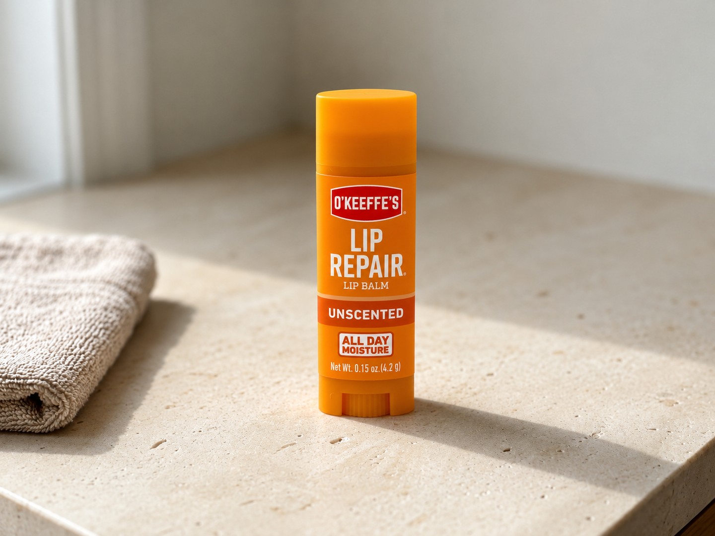 O’Keeffe’s Lip Repair Unscented on a warm stone vanity